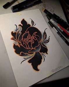 a drawing of a flower with orange and black flowers on it, surrounded by markers