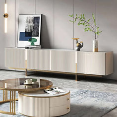 an elegant living room with modern furniture and art work on the sideboard, in neutral tones