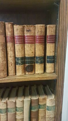 an old book shelf with many books on it