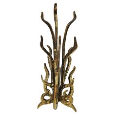 a metal sculpture with many branches hanging from it's sides on a white background