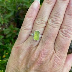 Do you need a gift for someone who is hard to buy for? Do you need jewelry for a tropical vacation or beach wedding? Sea glass jewelry is always a great gift to give! Here are the details about this ring:This is a small olive green piece of sea glass that is set in a fine & sterling silver fancy bezel and soldered to a sturdy band. All of our sea glass is found and never altered in any way. This piece was found in Europe somewhere! Handmade by Barb Macy in Corvallis, OR. Size 6 1/2 Adjustable Sea Glass Ring Jewelry, Handmade Sea Glass Ring Jewelry, Minimalist Green Jewelry With Recycled Glass, Green Recycled Glass Beach Jewelry, Green Recycled Glass Jewelry For The Beach, Recycled Glass Green Jewelry For Beach, Handmade Green Rings With Recycled Glass, Green Stackable Jewelry For The Beach, Beach-ready Green Stackable Jewelry