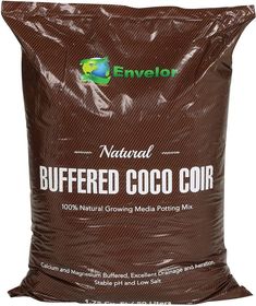 a bag of buffer coco coir sitting on top of a white table next to a bottle