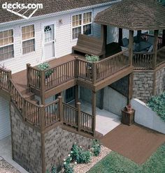 an aerial view of a two story house with decking and balconies on the second floor