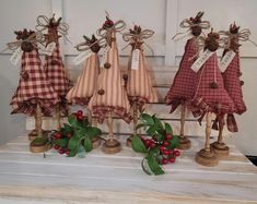 four wooden figurines with ribbons and bows on them