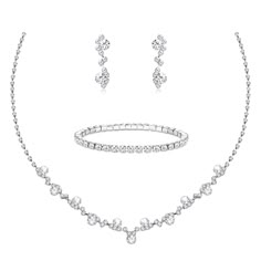 a necklace, bracelet and earring set in white gold with round brilliant cut diamonds