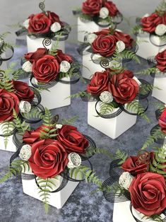 many red roses are placed in small white boxes