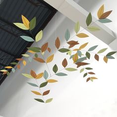 a wind chime hanging from the ceiling with leaves on it