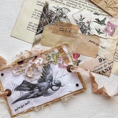 an assortment of old and new items are displayed on a wall with torn paper, tags, and other things