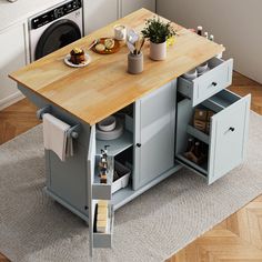 a kitchen island with two drawers and a cutting board on the top, in front of a washer and dryer