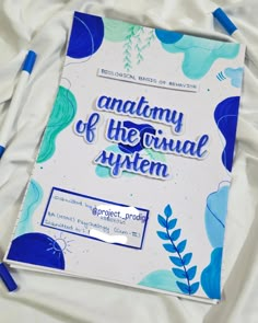 the anatomy of the individual system is displayed on a sheet of paper with blue markers