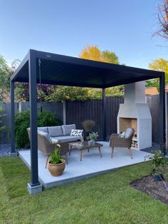 an outdoor living area with a fireplace and patio furniture