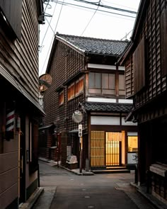 an alley way with wooden buildings on both sides