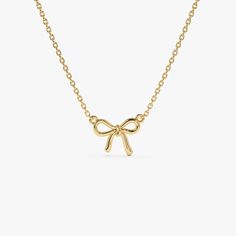 Discover the charm of our 14K Solid Gold Bow Ribbon Necklace, a minimalist design that symbolizes the tying of a knot. This elegant piece is perfect for bridesmaids, maids of honor, or your best friend, reflecting a bond of friendship and gratitude. Its sleek and simple bow design makes it an ideal birthday gift, offering a subtle yet beautiful addition to any jewelry collection. A thoughtful and stylish choice, this necklace serves as a memorable token for those closest to you. ▶ Details   * Made to Order  * Gold KT: 14K Solid Gold (also available in 18K & Platinum upon request)  * Length & Width: 10 x 7.75 MM * Ready to Ship in 1-2 Business Days ▶ See more of our Gold Necklaces - http://etsy.me/2lUxj86  ▶ See our storefront here - http://etsy.me/2lUcVnH  ▶ All store sections here  Diamon Gold Necklace With Bow For Gifts, Elegant Gold Necklace With Bow, Gold Dainty Bow Jewelry, Gold Bow Necklace, Elegant Bow Pendant Necklace, Ribbon Necklace, Bow Necklace, Gold Armband, Ruby Jewelry