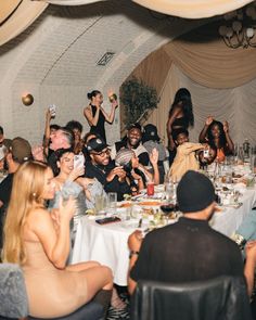 a group of people sitting around a dinner table