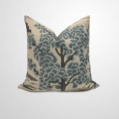 a blue and white pillow with trees on it