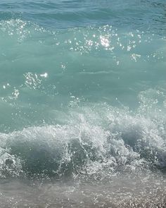 a person riding a surfboard on top of a wave in the ocean at the beach