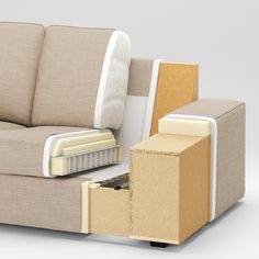 a couch with an open drawer on the bottom and side, in front of it