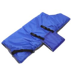 the blue sleeping bag is folded up on top of it's own zippered pouch