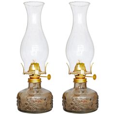 two glass vases sitting side by side on top of each other