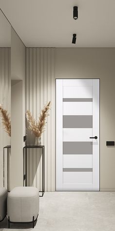 an empty room with a white door and two stools in front of the door