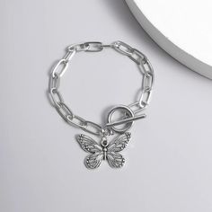 Introducing Our Stunning Butterfly Pendant Chain Bracelet Welcome to our store, where elegance meets affordability! Our Butterfly Pendant Chain Bracelet is a timeless piece that adds a touch of grace to any outfit. Crafted with precision and passion, this bracelet embodies the essence of charm. This bracelet is designed for the modern woman who appreciates beauty and quality. With its straight-line buckle chain and delicate butterfly pendant, it effortlessly blends Korean fashion sensibilities with international appeal. Embrace your femininity with this exquisite piece, perfect for both casual outings and special occasions. Product Features: Chain & Link Bracelet Made of high-quality zinc alloy Charming bowknot design Easy-hook clasp for convenience Available in a stunning silver color Lig Minimalist Silver Alloy Bracelets, Trendy Stainless Steel Charm Bracelet, Dainty Silver Stainless Steel Chain Bracelet, Alloy Chain Bracelet, Silver Chain Alloy Bracelet Gift, Nickel Free Link Bracelets, Nickel-free Link Bracelets, Minimalist Alloy Charm Bracelet Gift, Minimalist Alloy Chain Bracelet Gift