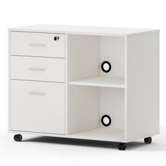 a white cabinet with three drawers and two black circles on the bottom one drawer is open