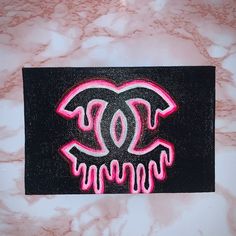 a pink and black painting on a marble surface