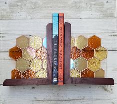 two bookends made out of stained glass and wood are sitting on the wall