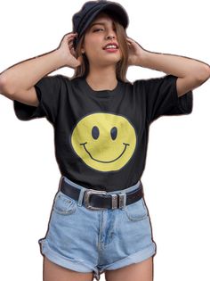 a woman in shorts and a t - shirt with a smiley face on it