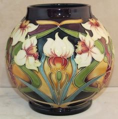 this is a vase with flowers painted on it