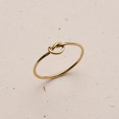 Dainty and delicate, the Love Me Knot Ring is one of the sweetest additions to our stacking kellection. Made to remember the ties to our loved ones, this beauty is the perfect gift for the special someone in your life or to permanently have your nearest and dearest close at hand. Classic Midi Rings In Recycled Gold As A Gift, Classic Midi Rings In Recycled Gold For Gifts, Classic Stackable 14k Gold Filled Rings As Gift, Classic 14k Gold Filled Stackable Rings Gift, Dainty Tiny Midi Rings As Gift, Tiny Classic Stackable Rings For Gift, 14k Gold Filled Open Midi Rings As Gift, Dainty Midi Rings For Gifts, Classic Tiny Stackable Rings For Gift