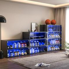 a living room filled with furniture and a basketball on top of the wall next to a window