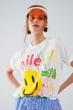 Introducing the Graphic "Smile With Me" Text T-Shirt in White, a statement piece that blends Italian craftsmanship with casual comfort. Crafted from 100% cotton, this t-shirt ensures a soft and breathable feel, ideal for everyday wear.  Designed with an abstract print and featuring a crew neckline and short sleeves, this shirt offers a relaxed fit that runs true to size. The front showcases a playful "Smile With Me" text, adding a touch of charm and positivity to your outfit.  The model, standing at 5'10" with measurements of 31-24-35, effortlessly showcases the t-shirt in size U. Known for its casual appeal, this piece is perfect for pairing with your favorite jeans or shorts for a laid-back look.  Embrace comfort and style with the Graphic "Smile With Me" Text T-Shirt in White, a versati Text T Shirt, Fashion Must Haves, Text Me, Fit Style, Casual Wardrobe, Favorite Jeans, Abstract Print, Fabric Cotton, Your Outfit