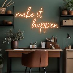 a desk with a neon sign that says make it happen on the wall above it