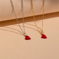 Let your big heart be showcased with our dainty Red Heart Necklace. The cherry red heart charm is minimalist and perfect for layering with any other chains in your collection. This charm necklace is a trendy yet everyday design to throw on and add brightness to a simple outfit. Material: High Quality Solid 925 Sterling Silver Finish: Sterling Silver ∙ 18K Gold Featuring a ~8 x 6mm Red Enamel Heart Charm with minimalist cable chain adjustable 16 inches to 18 inches SKU: RR-NR141 Trendy Red Heart-shaped Jewelry, Trendy Red Heart Beads Necklace, Minimalist Red Heart-shaped Jewelry, Trendy Heart Charm Necklace With Delicate Chain, Trendy Heart-shaped Charm Necklace With Delicate Chain, Trendy Red Jewelry With Heart Charm, Dainty Red Necklace For Her, Dainty Red Necklace As Gift For Her, Trendy Heart Print Jewelry For Gifts