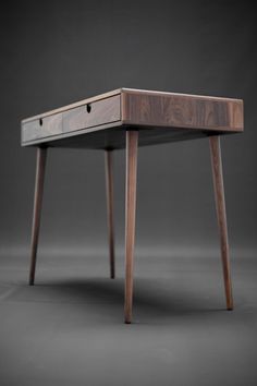 a wooden desk with two drawers on one side and an open drawer on the other