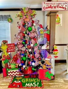 a christmas tree decorated with candy canes and other holiday decorations in a living room