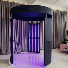 a purple and black room with curtains on the windows