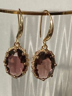 18k gold plated amethyst purple crystal diamanté ornate deep set oval crystal cabochon drop charm earrings many others colours in the range  The earwires are nickel free,18k gold rhodium plated on a copper base metal Party Jewelry With Gemstones In 14k Gold, Party 14k Gold Gemstone Jewelry, Party Jewelry In 14k Gold With Gemstones, 14k Gold Gemstone Jewelry For Parties, Classic Pendant Jewelry, Nickel-free, Amber Oval Pendant Jewelry For Formal Occasions, Classic Nickel-free Pendant Jewelry, Classic Purple Jewelry For Formal Occasions, Elegant Drop Gemstone Jewelry