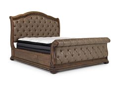 a bed with a brown leather headboard and foot board on it's side