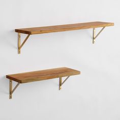 two wooden shelves with metal brackets on them