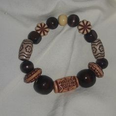 Handmade wooden bracelet it was created by my mother.  For men or women.  Stretchy Boho style Handmade Traditional Brown Bracelets, Brown Wooden Beaded Bracelets As A Gift, Brown Wooden Beaded Bracelet As A Gift, Traditional Handmade Brown Beaded Bracelets, Rustic Wooden Bead Bracelet, Wooden Beaded Bracelets As Gift, Spiritual Brown Bracelets With Wooden Beads, Traditional Handmade Brown Stretch Bracelet, Traditional Wooden Bracelets With Round Beads