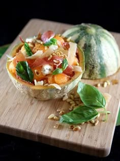 two gourmet food items sitting on a cutting board next to some green leaves