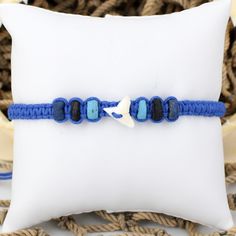 Shark Tooth Bracelet Adjustable Braided Macramé Cord Blue Black Beads 6293-9 #SharkToothAnklet #AnkleBracelet #SharksTeeth #SharkToothBracelet #BeachJewelry #FriendshipBracelet #GrassShackTrading #anklet #SharkTooth #SharkWeek Blue Braided Bracelet With Sliding Knot, Blue Beaded Jewelry With Adjustable Cord, Adjustable Hand-strung Blue Friendship Bracelets, Blue Beaded Bracelets With Adjustable Cord, Blue Braided Bracelet With Sliding Knot For Beach, Blue Adjustable Friendship Bracelets With Round Beads, Blue Beaded Jewelry For The Beach, Blue 8mm Bead Jewelry For The Beach, Adjustable Blue Beaded Bracelets 8mm