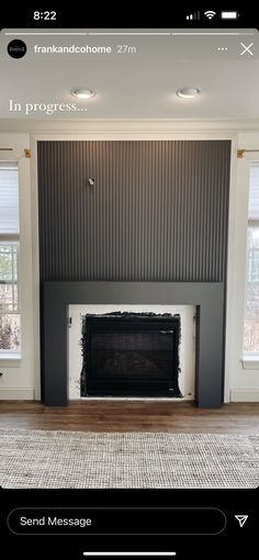 an empty living room with a fireplace and windows