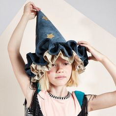 This witch's/wizard's hat, with ruffle details, is very stylish indeed. It is crafted from blue velvet, with gold lamé and gold glitter stars and moons. An essential accessory for Halloween, or to add to a dressing up box for imaginative play any time of the year. The hat is made from soft blue velvet It has ruffle details on the brim made from blue velvet and shiny gold lamé It has a blue velvet elastic strap with a hook and loop fastener Gold glitter stars and moons add a delightful embellishm Stars And Moons, Gold Glitter Stars, Ren Fest, 일본 패션, Authentic Models, Meri Meri, Glitter Stars, Blue Hat, Turbans