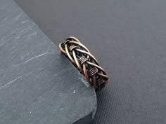 This intricate, yet simple band ring it is perfect for men or women, it is the ideal alternative wedding band. It is made of solid copper wire braided and shaped by hand. In the end is oxidized to enphacize all the details. The ring band is 5 mm/ 0.2 inches wide. I make all ring sizes, if your size is not in the variations please leave in checkout your size. If you are in doubt of your ring size leave your finger circumference. See the cuff bracelet matching this ring  https://www.etsy.com/listing/1307128206/braided-copper-cuff-bracelet-couples My items are 100% handmade. Each one is made in the design shown however, will have slight variations, they are made one at a time so, always unique. ### Items ready to ship in 3-5 days. Allow 2-4 weeks in transit to arrive to you. To see my main sh Wire Wrap Ring For Men, Mens Copper Ring, Men Wire Ring, Mens Wire Rings, Viking Rings For Men, Copper Rings Women, Wire Wrapped Rings For Men, Wire Jewelry For Men, Men’s Wire Wrapped Ring