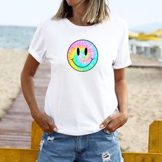 Tie-Dye Smiley Face Retro Aesthetic T-Shirt ﻿The model is wearing white. Despite every effort to provide accurate images of each product and design the colors may vary slightly, due to different device screen settings and photography lighting. Please be aware that our clothes are not oversized. If you desire an oversized look we recommend ordering 2-3 sizes larger than how you size on our size guides. Classic Fit 100% Cotton Preshrunk jersey knit Seamless double-needle 7/8" collar Taped neck and Trendy White Crew Neck T-shirt, Trendy Smiley Face Crew Neck T-shirt, Trendy Crew Neck T-shirt With Smiley Face, White Relaxed Fit Top With Smiley Face, White Smiley Face Top With Relaxed Fit, Trendy White Printed T-shirt, White Printed Casual T-shirt, Casual White Printed T-shirt, White Graphic Tee With Smiley Face