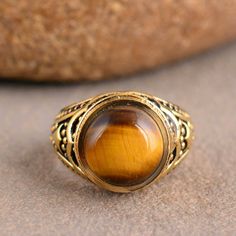 "Tiger Eye Ring, Handmade Ring, Wedding Ring, Tiger's Eye Ring, Gift For Her, Anniversary Ring, Promise Ring, Dainty Ring, Mothers Day Gift Size:- All Size Available In Variation Metal:- Silver Stone:- Tiger Eye Size:- All Size Available In Variation Metal:- Brass 1 product free gift on purchase of 3 products. You can choose the plain brass ring free gift as your wish. Take a screenshot of plain brass ring you like from my shop and send me a photo in personal message. MUST READ....👇 5 stars is my shop's priority. So contact me before leaving any negative review. I am here only for my dear customers. it is poor Etsy manners to Leaving a negative review without conversation with your seller. If you are not satisfied with my jewelry, then please contact me, I will solve your problem. ❥ Custo Gold Crystal Ring For Marriage, Gold Gemstone Rings For Marriage, Spiritual Round Rings For Anniversary, Handmade Brown Ring For Wedding, Brown Round Rings For Anniversary, Antique Brown Wedding Rings, Tiger Eye Ring, Tigers Eye Gem, Obsidian Ring