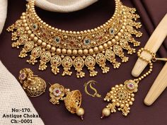 Description :- Gold Choker Necklace Sets / South Indian Jewelry/Punjabi Choker/ Temple Necklace /Antique Wedding choker Necklace/Indian Wedding Jewelry All the raw material used in this product is of high quality and is handcrafted with love. Premium Quality and High craftsmanship 100% Satisfaction Guarantee: Long Lasting Plating, High-Quality Stones. Gifting: This pair of charming necklace and earrings come in a beautiful gift box, making it an ideal gift for birthday, wedding anniversary or we Mehndi Dress For Bride, Choker Necklace Indian, Amrapali Jewellery, Wedding Choker Necklace, Indian Gold Jewellery Design, Choker Sets, Temple Necklace, Unique Gold Jewelry, Bridal Jewelry Sets Brides